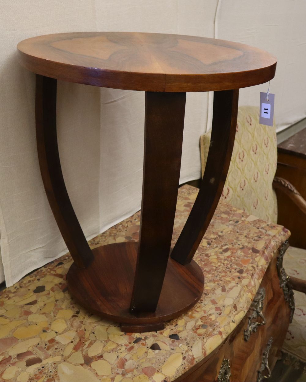An Art Deco style figured walnut circular two tier occasional table, 55cm diameter, H.60cm